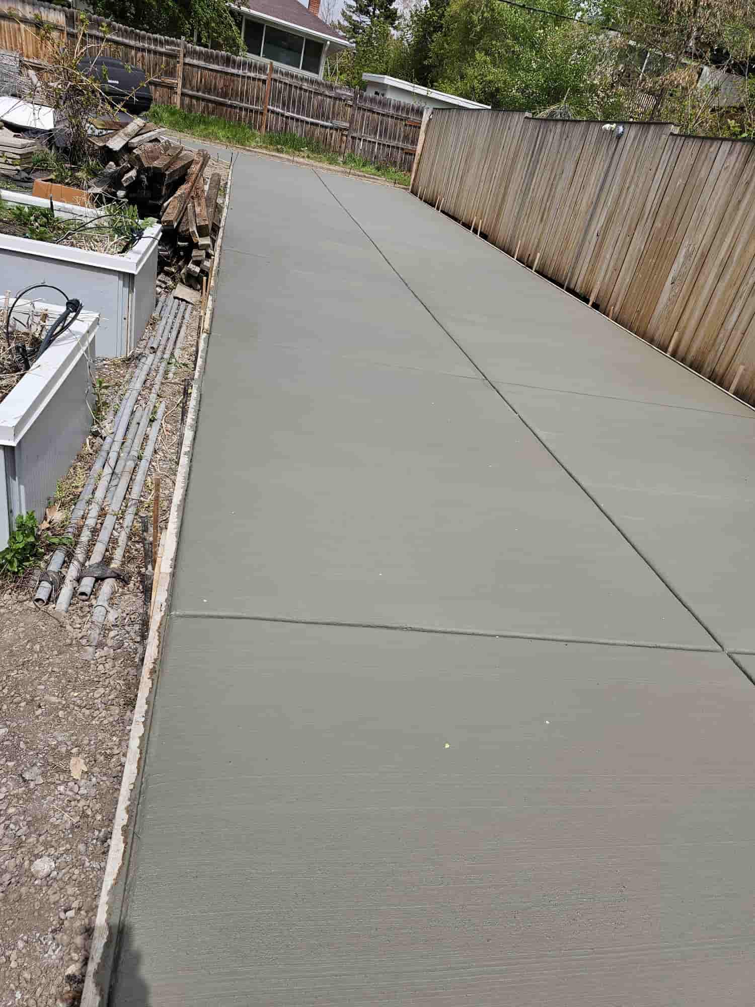 Concrete flatwork poured neatly around two basement window wells